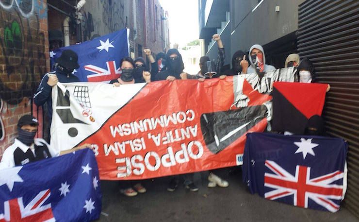 A photograph of some anti-fascists in Naarm presenting for the camera some patriotik tat kindly donated by a now-defunct far-right groupuscule.