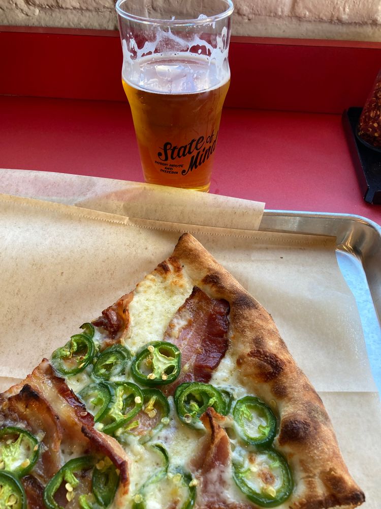 A glass of beer, Pliny the elder. Bacon & jalapeño pizza slice.