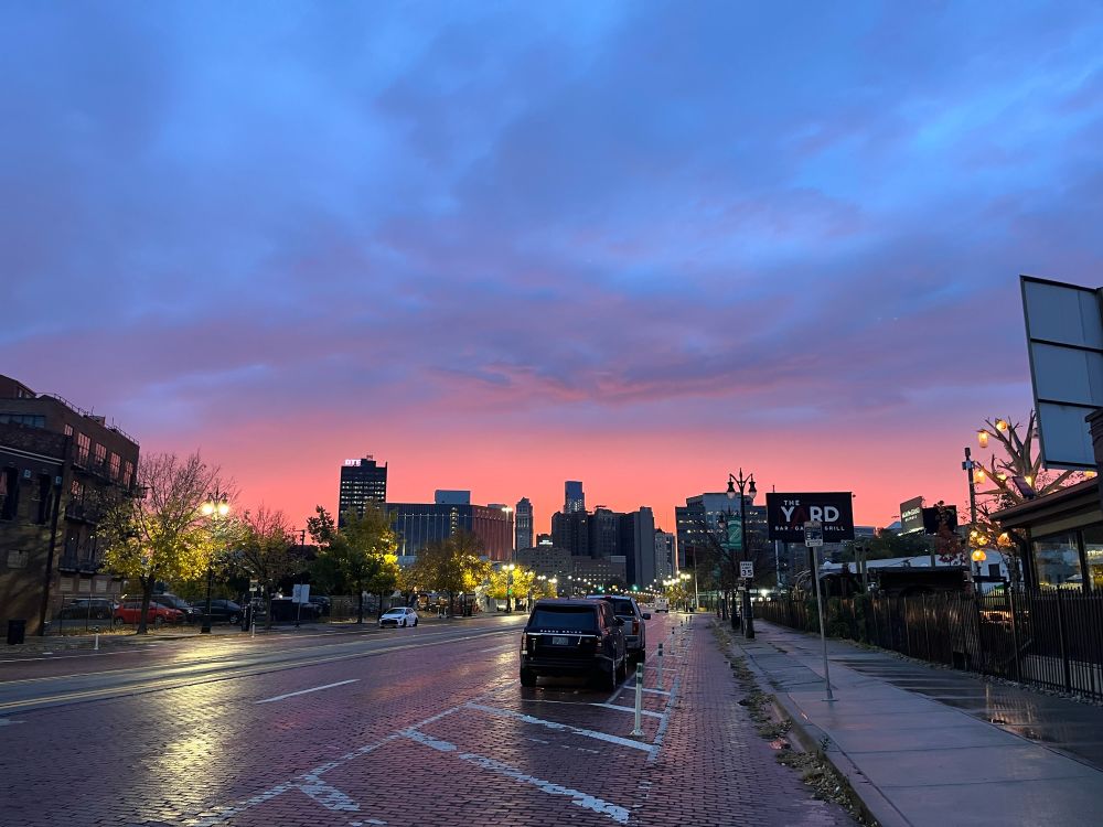 Pink sky about buildings from the street