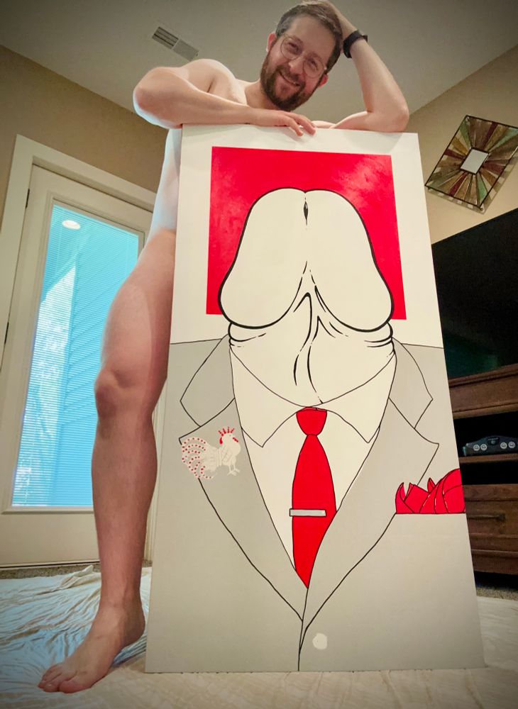 Naked bearded gay boy in glasses stands behind his huge canvas featuring a painted dick in a suit with a red square background behind it. #gaygaygay