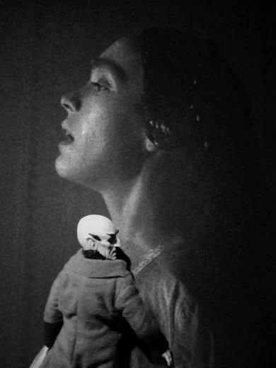 The Count Orlok toy leaning up against Ellen on the movie poster as if holding her. The picture is black and white.