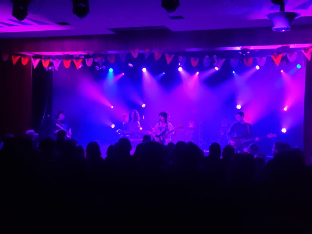 Five piece rock band, Lunar Vacation, bathed in purple and blue stage lights, playing at the Shrine Ballroom in Boise, March 30, 2025. 