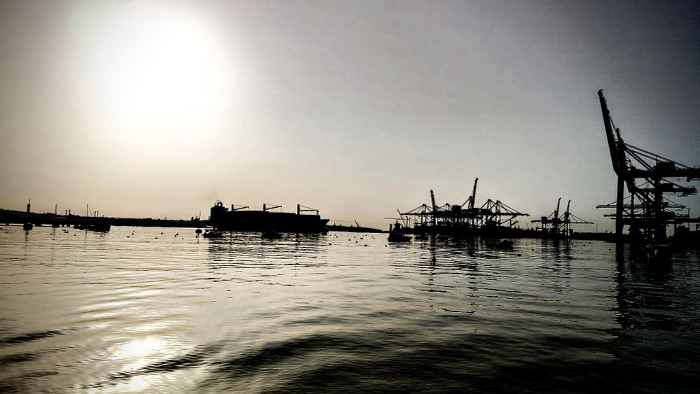 A silhouette of an ocean and a Freeport in Malta