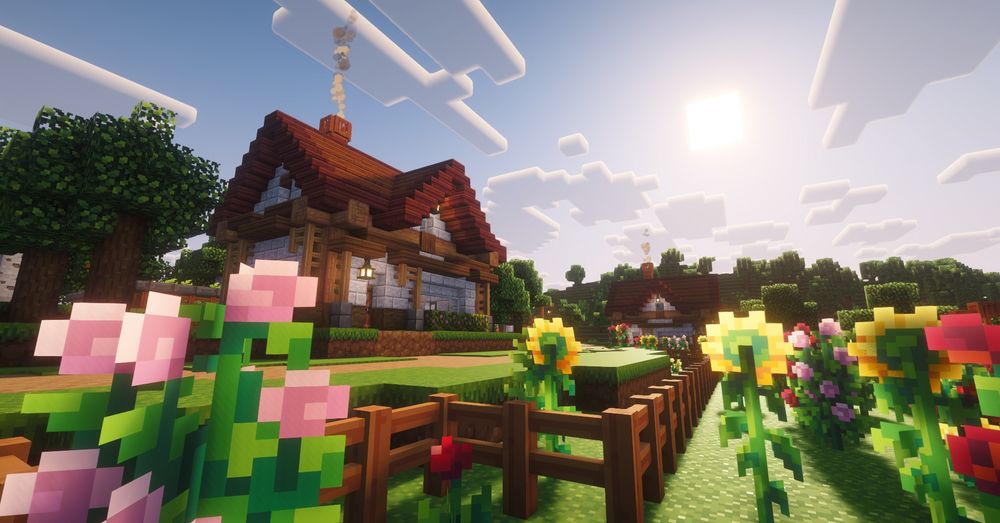 A Minecraft screenshot of a flower garden in front of a small one story house at sunrise.