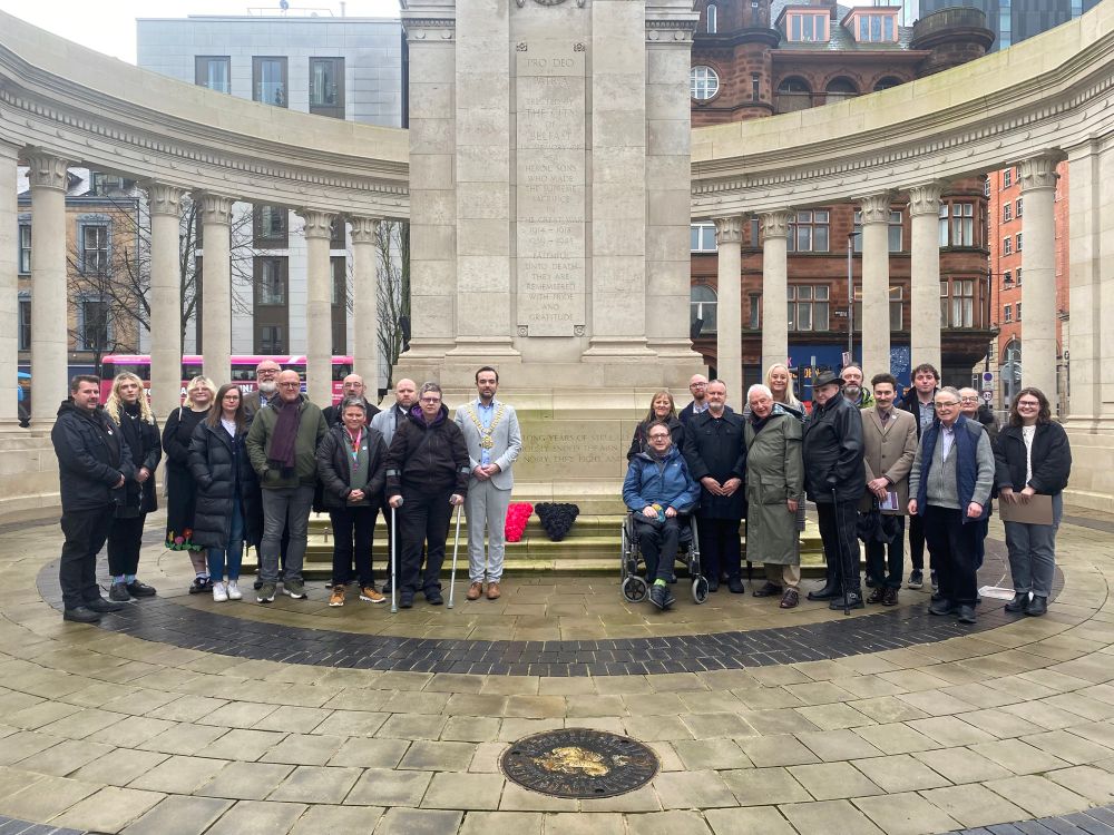 A picture of me with activists laying flowers at the cenotaph at Belfast City Hall 