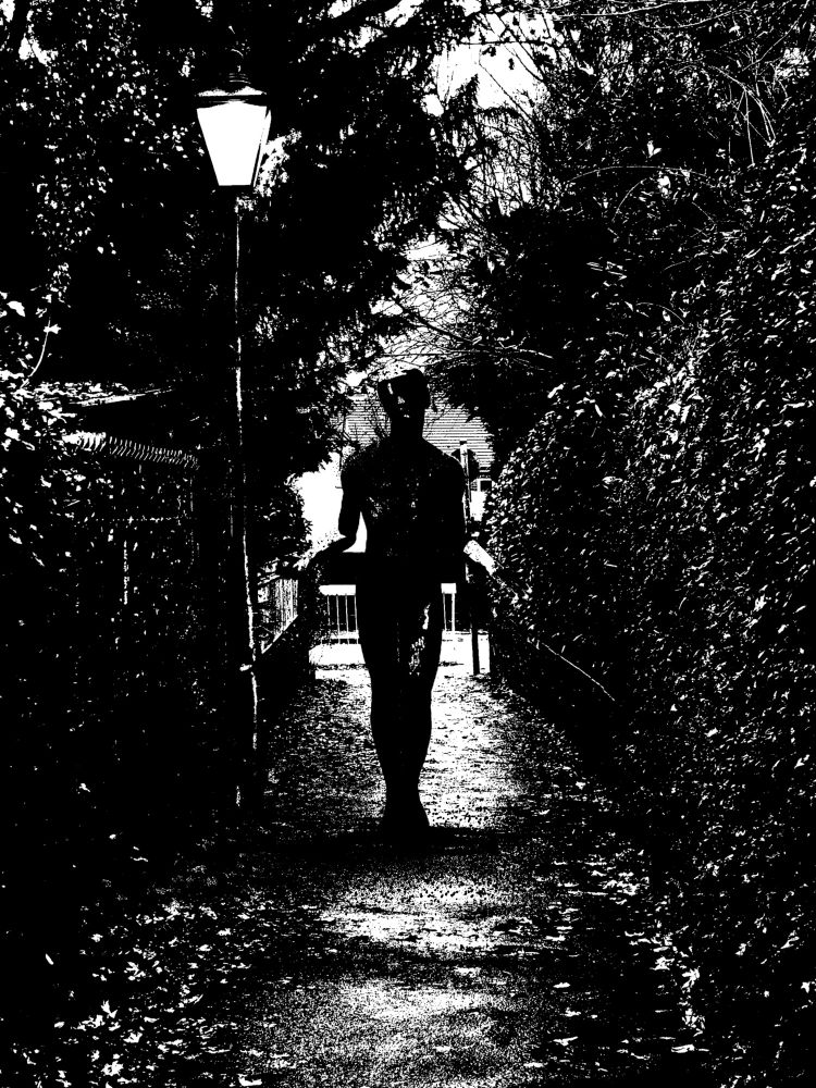Strange figure stood under street light in an alleyway. 