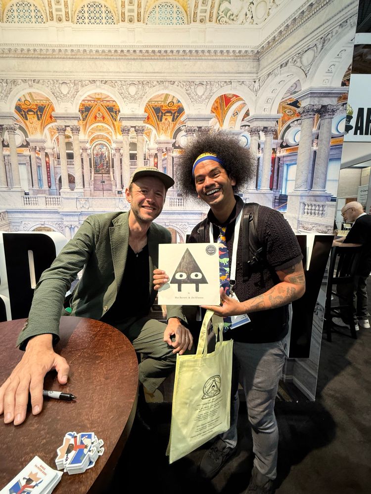 Mac Barnett and Mychal smile together for a photo 