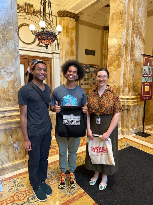 Mychal smiles with Milwaukee Library workers 