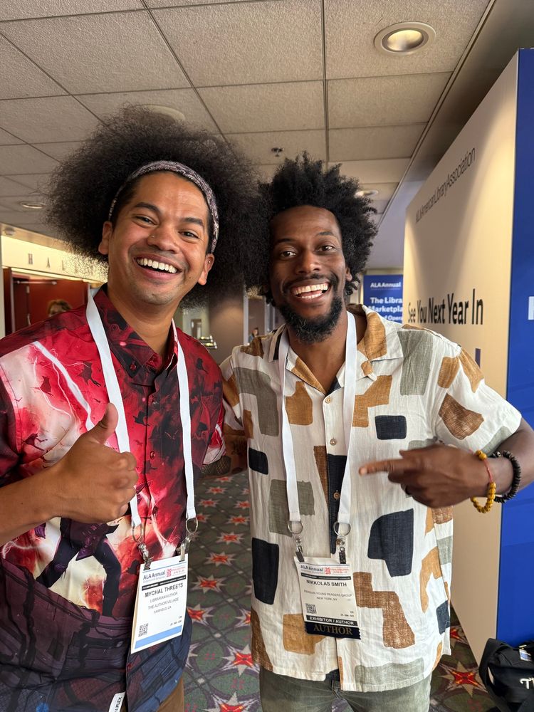 Mychal and Nikkolas Smith smile together for a photo 