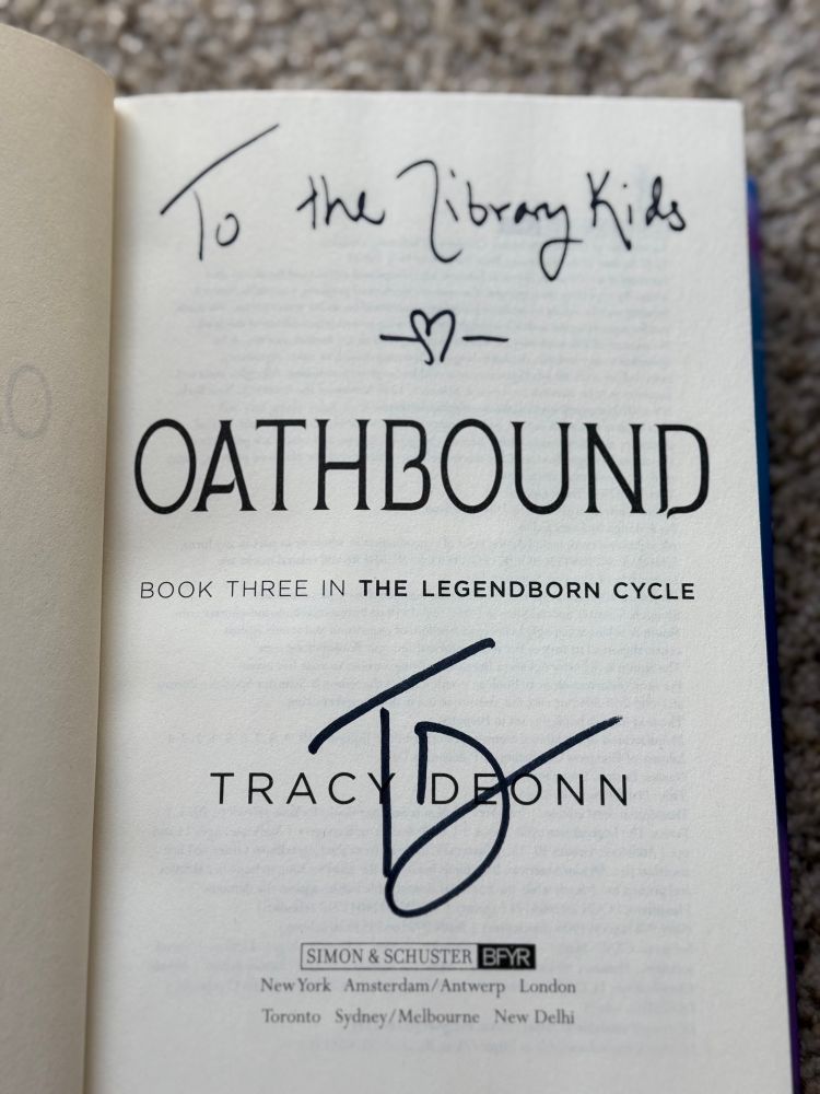 A signed copy of Tracy Deonn’s OATHBOUND book (signed “To the Library Kids”)