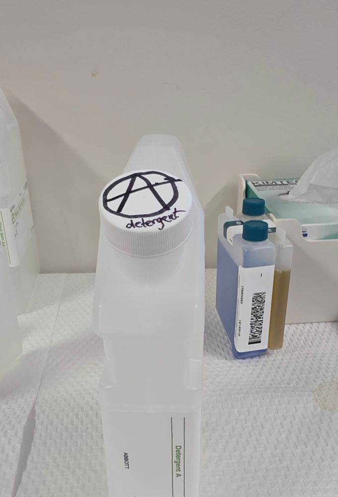 A vial of detergent A labeled with an anarchist symbol