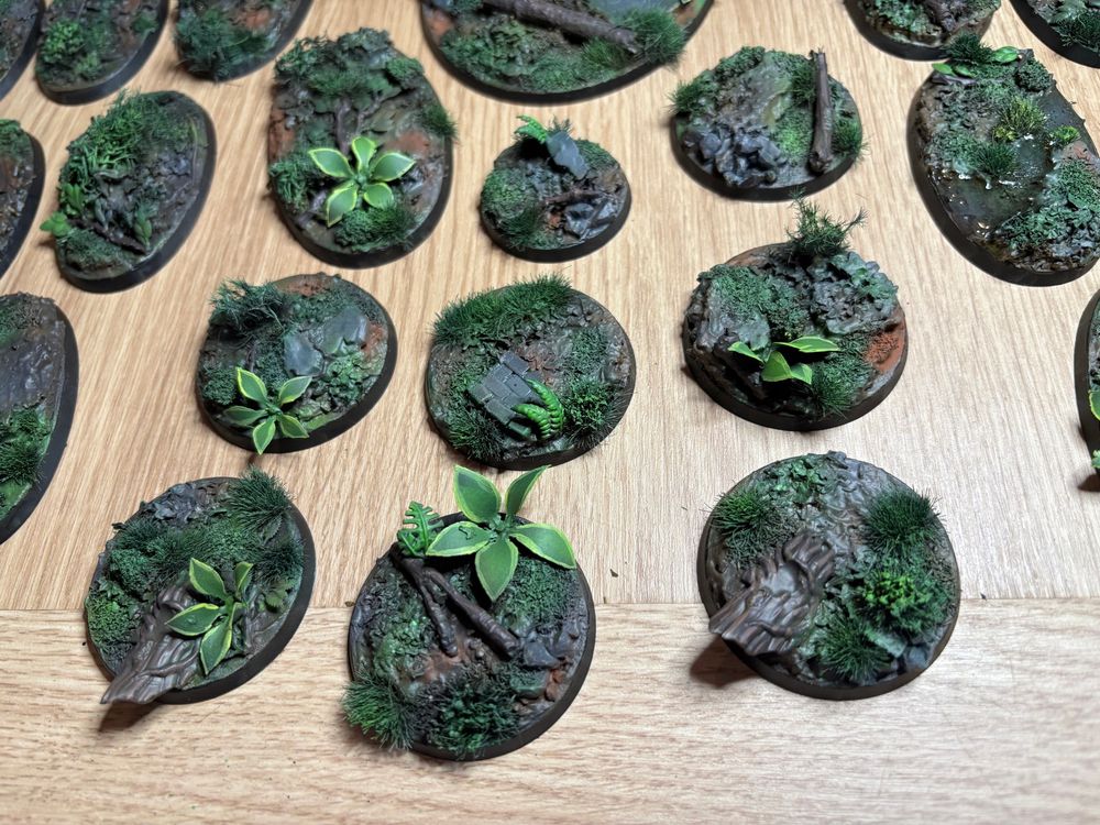 A selection of completed forest bases for Age of Sigmar