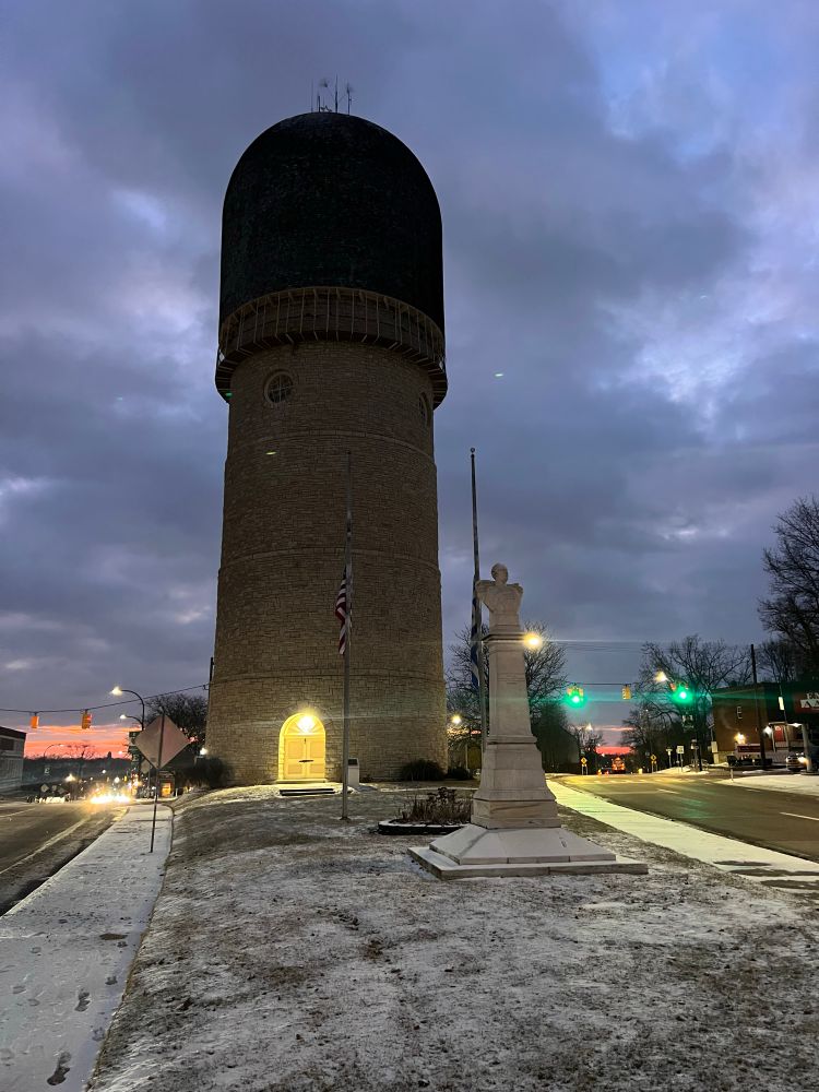 The Ypsilanti water tower on a cold morning looking east. The sun is peeking through the clouds on the horizon. 