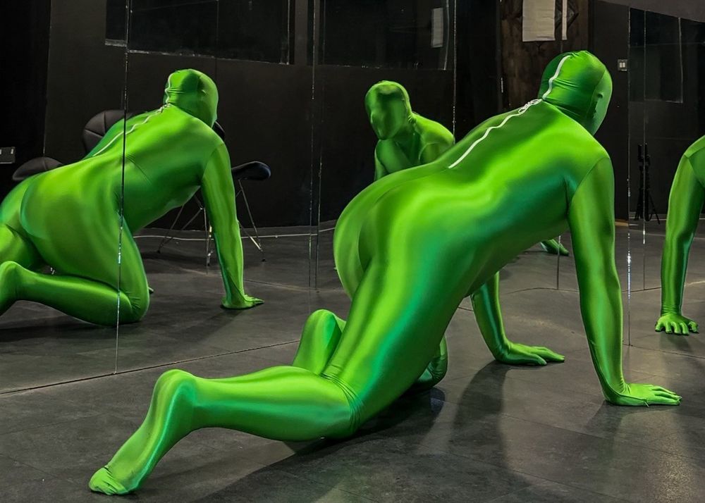 Man in shiny green lycra spandex zentai suit