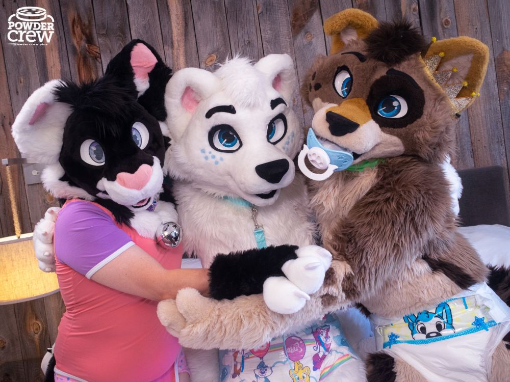 Snoozy (left), Wuffles (middle), Moka (right). Three fursuiters wearing diapers and hugging each other from side to side.
