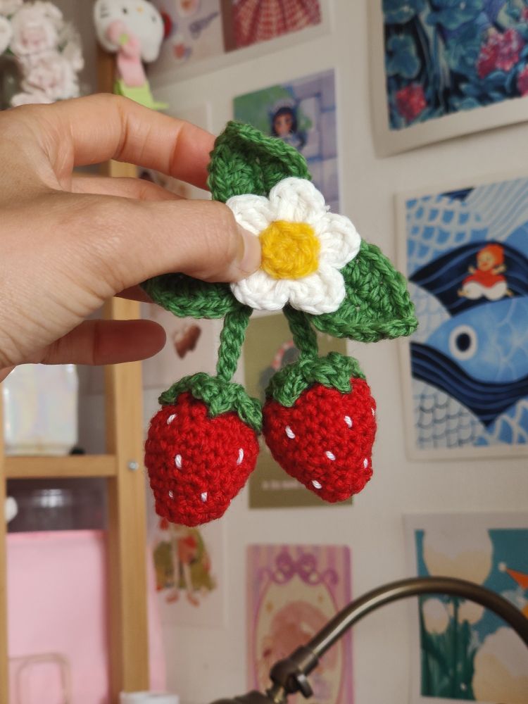 Crochet strawberries with leaves and a flower