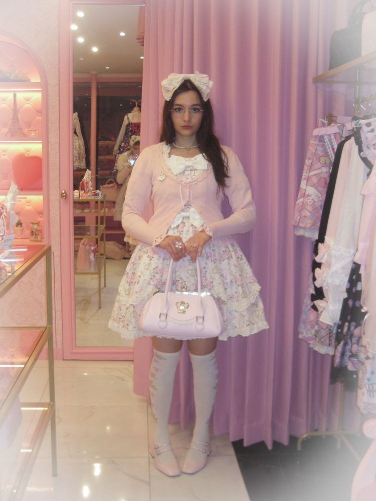 Lolita coordinate picture inside of Angelic Pretty Paris store. I'm wearing the ivory version of Angel Grosgrain OP by Baby the Stars Shine Bright. My cardigan, headbow, bag and socks are also from Baby, shoes are offbrand.