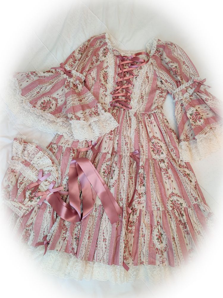 Flatlay of Métamorphose temps de fille Antique Bouquet OP & Bonnet in pink