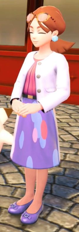 A character from "Pokemon Legends Z-A."

She wears a light lavendar cropped jacket, a dark purple top, and a purple skirt with various blue spots on it. 