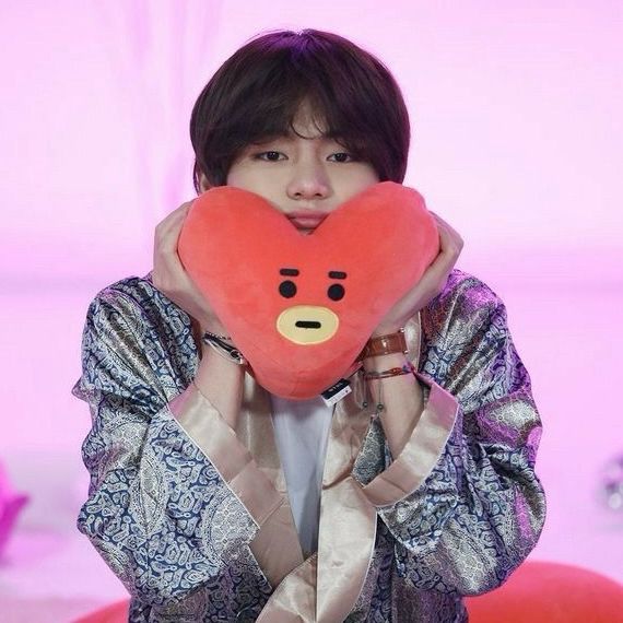 Taehyung from Run BTS episode 97 squishing a tata plush to his chin giving him the ultimate bread cheekies