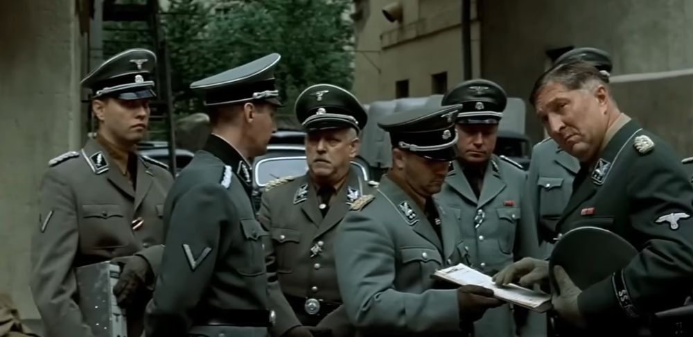 A group of Nazis wearing SS uniforms with the Totenkopf or "Death's Head" on the cap from the movie Downfall