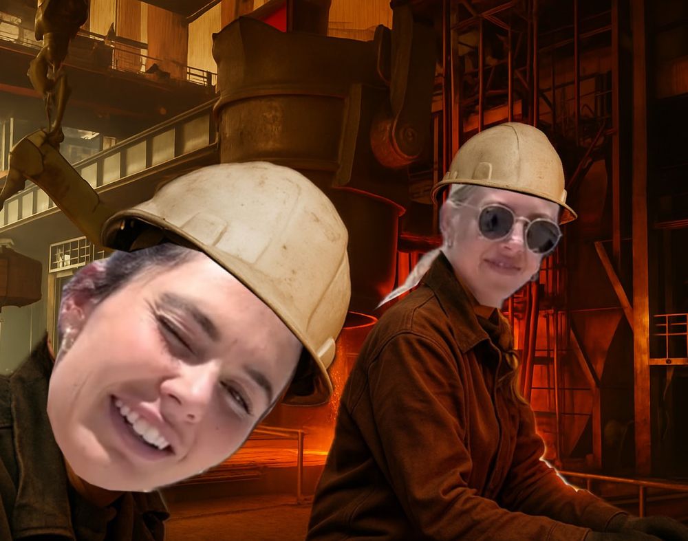 darby takes a selfie of herself and callie in the steel mill. both wear foundry gear. a ladle prepares to pour molten metal in the background