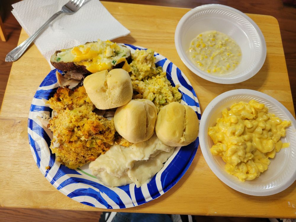 Roasted turkey, smoked turkey, dressing, broccoli casserol,  mac and cheese, creamed corn, mashed potatoes, twice baked potatoes, and rolls. Not pictured: fruit salad, chocolate pie, cookies, brownies, and pumpkin bread