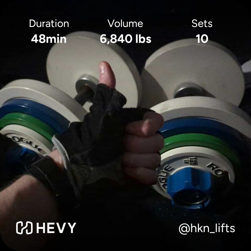 poorly lit thumbs up in front of two 47.5 lb dumbbells, hevy app overlay reads 48 min duration, 6,840 lbs volume, 10 sets