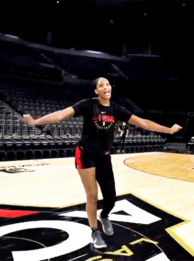 a woman wearing a shirt that says las vegas on it is dancing on a basketball court