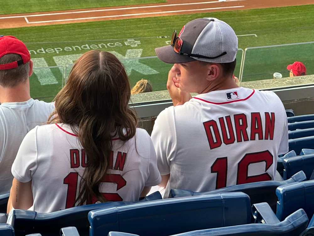 Two people next to each other at the Phillies–Red Sox game wearing Duran jerseys