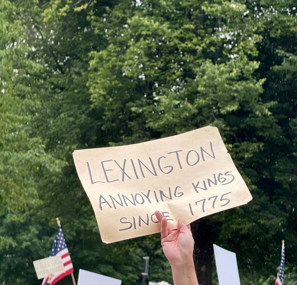 Protest sign which says “Lexington: annoying kings since 1775”