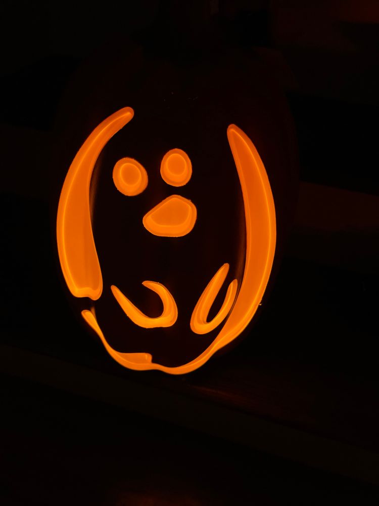 Showing a ghost silhouette of the light up pumpkin. 
