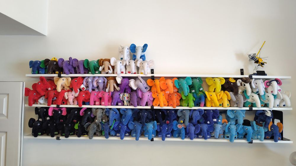 Three white shelves with PHP elephpants. The top shelf is only a single layer, and also holds a Lego model of the Cassini spacecraft. 