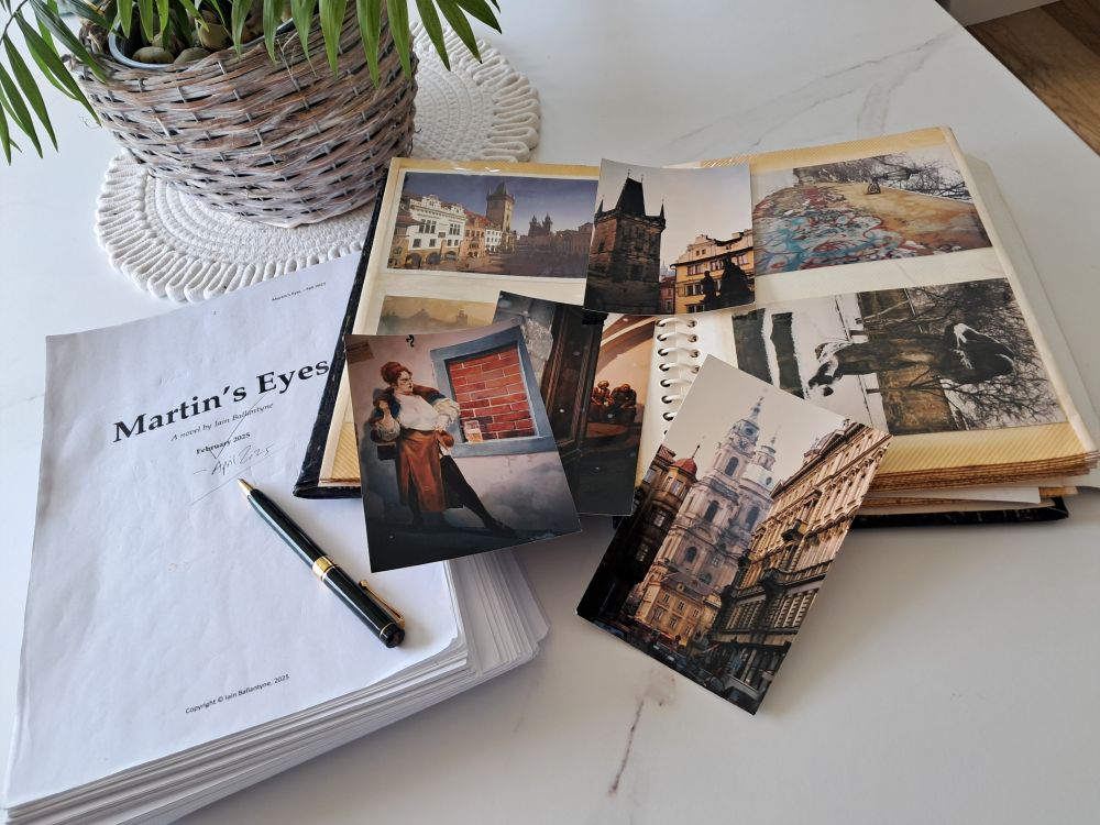 A pic including a potted plant, a photo album, draft manuscript and pen, to illustrate progress being made in producing the novel 'Martin's Eyes' by Iain Ballantyne. To be published by Chiselbury in the first half of 2026. Photo: Iain Ballantyne.

