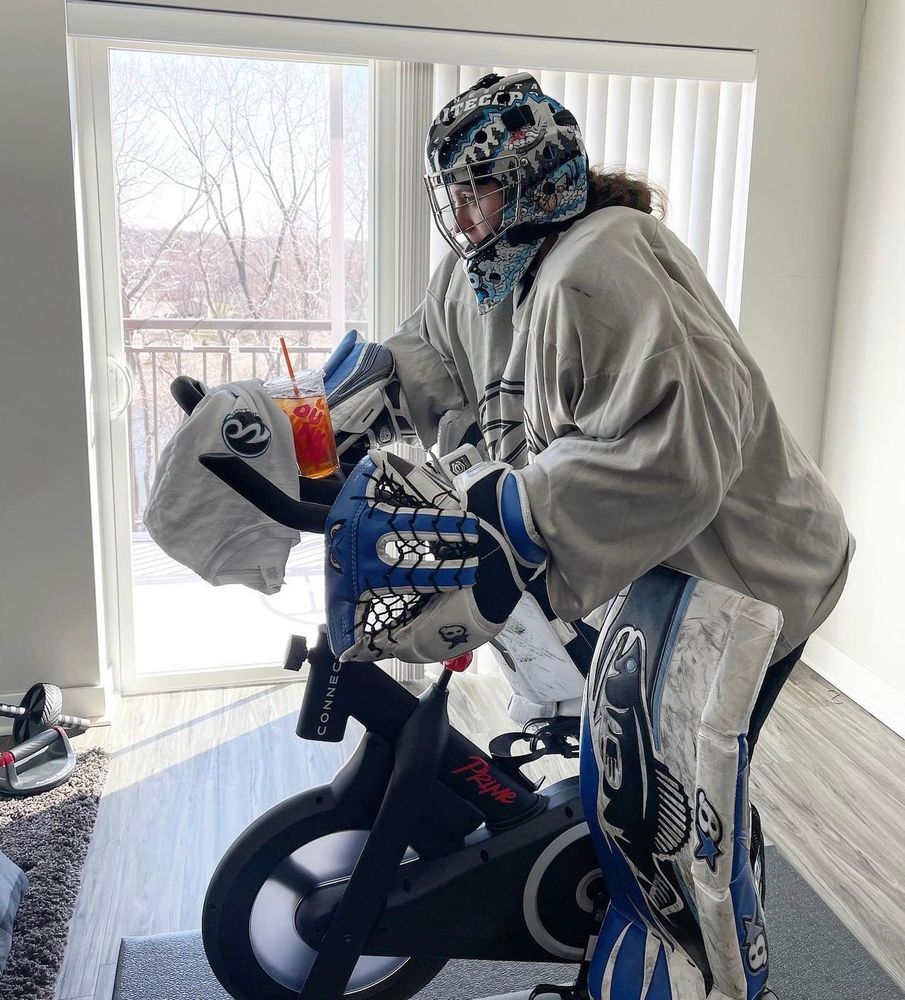 Goalie riding a stationary bike 