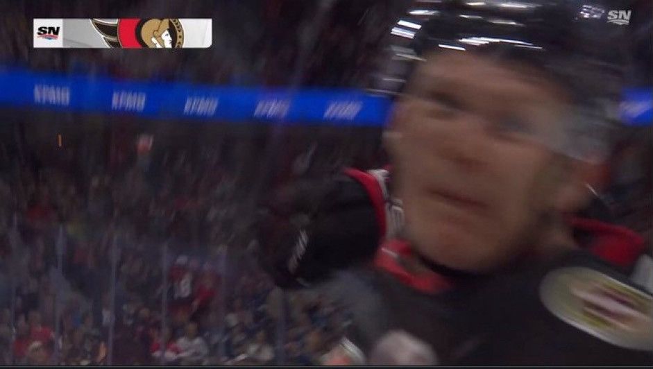 -what appears to be a Sens player punching the camera.