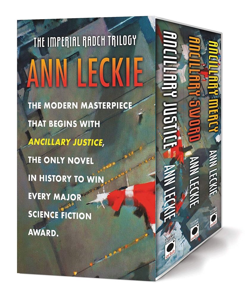 Picture is of boxed set of Imperial Rach trilogy by Ann Leckie, the following is copied from Google Books:

This special boxed set contains all three novels in NYT bestselling author Ann Leckie's Hugo, Nebula, and Locus award-winning space opera trilogy about a ship's AI who becomes trapped in a human body, and her quest for revenge.
"There are few who write science fiction like Ann Leckie can. There are few who ever could." -- John Scalzi
On a remote, icy planet, the soldier known as Breq is drawing closer to completing her quest.
Breq is both more than she seems and less than she was. Years ago, she was the Justice of Toren-- a colossal starship with an artificial intelligence linking thousands of corpse soldiers in the service of the Radch, the empire that conquered the galaxy.
An act of treachery has ripped it all away, leaving her with only one fragile human body. And only one purpose-- to revenge herself on Anaander Mianaai, many-bodied, near-immortal Lord of the Radch.
Ann Leckie's Imperial Radch trilogy has become one of the new classics of science fiction. Beautifully written and forward thinking, it does what good science fiction does best, taking readers to bold new worlds with plenty explosions along the way. 