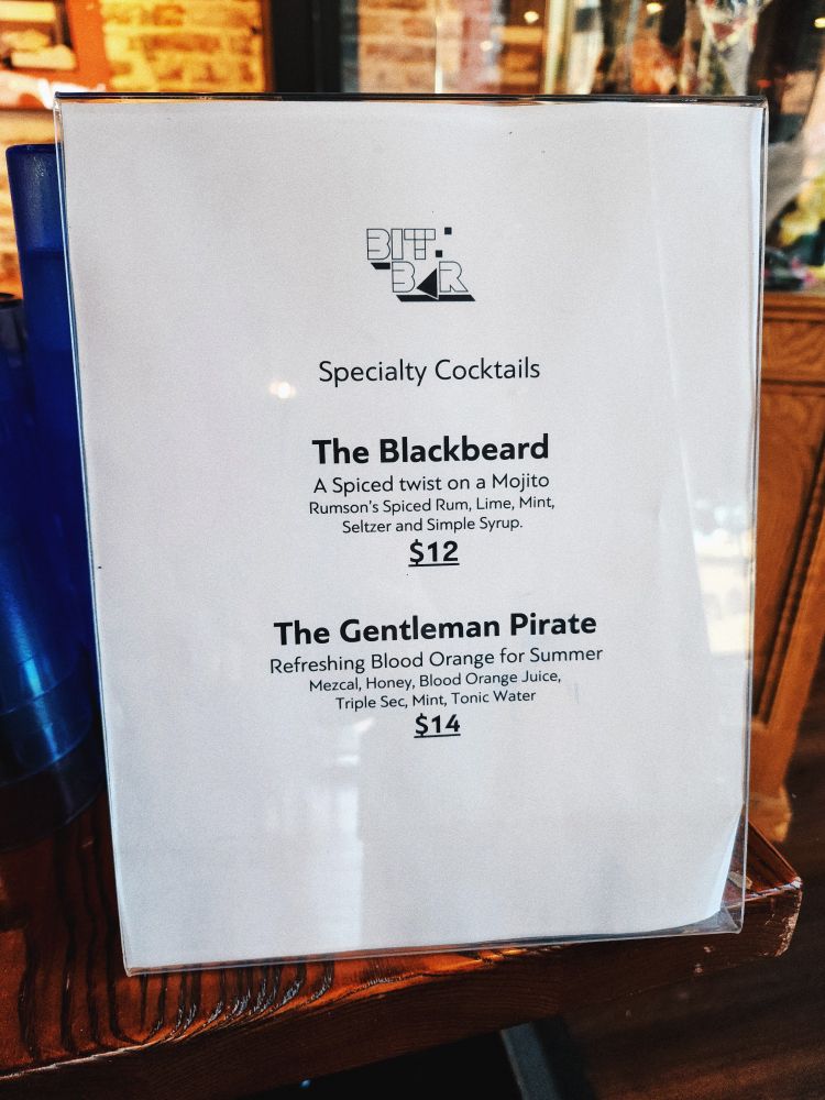 A listing for specialty cocktails. "The blackbeard- a spiced twist on a mojito. Rumsons spiced rum, lime, mint, seltzer, and simple syrup" and "the gentleman pirate- refreshing blood orange for summer. Mezcal, honey, blood orange juice, triple sec, mint, tonic water"