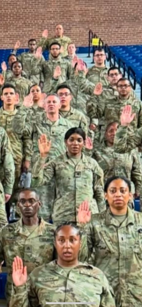 People being sworn in wearing military fatigues