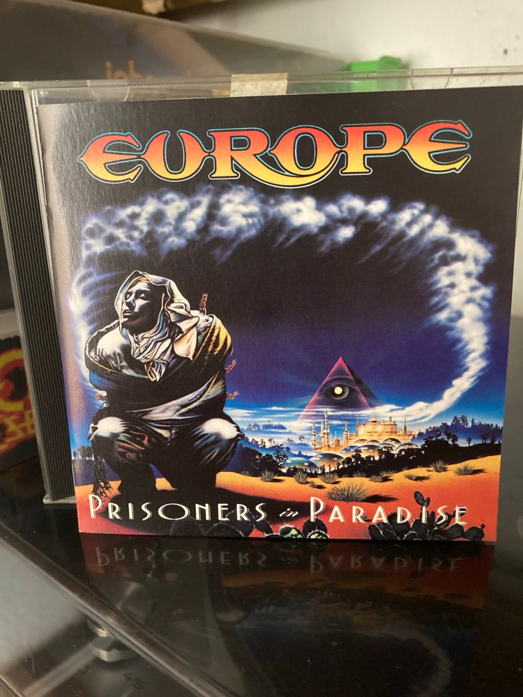 Front of booklet of Europe  – Prisoners In Paradise CD album.