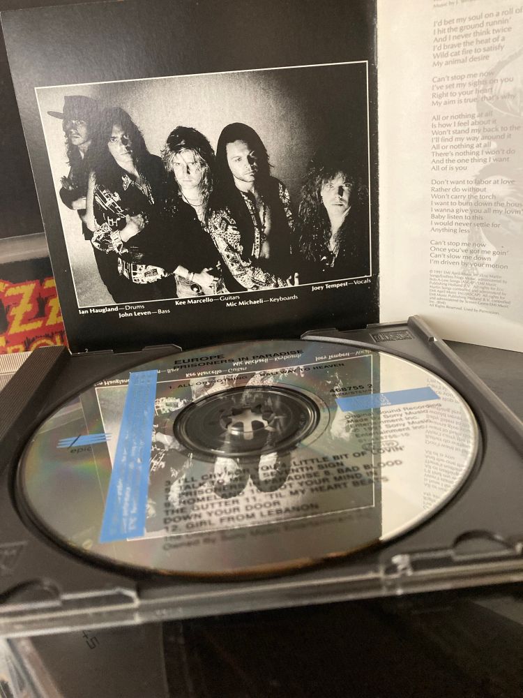 Detail of CD in tray and inside of booklet of Europe  – Prisoners In Paradise CD album.