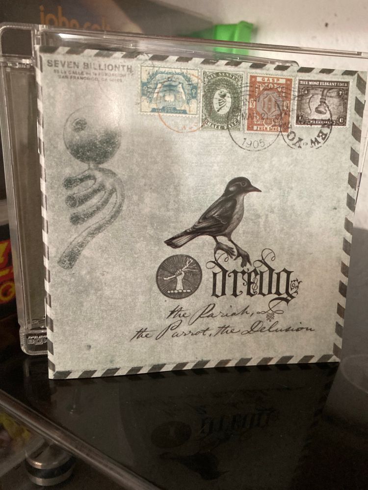 Front of booklet of Dredg - The Pariah, The Parrot, The Delusion CD album.
