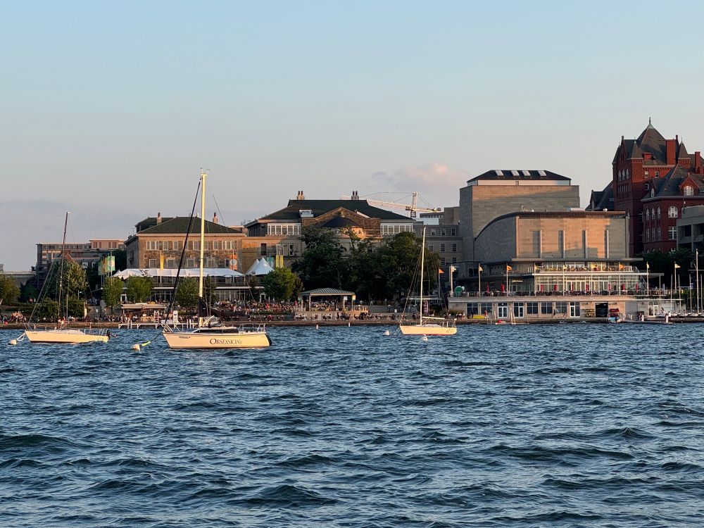 Photo of University of Wisconsin Memorial Union and sailboats, from the water. 