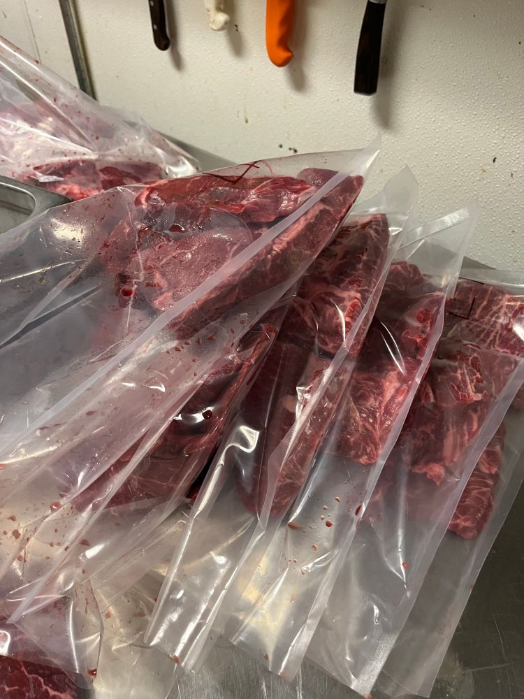 Vacuum sealed bags containing steaks