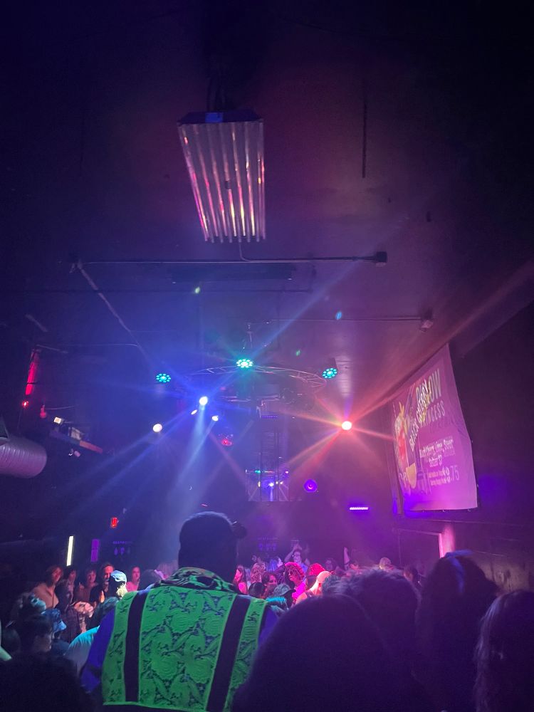 Gay bar with flashing lights and people dancing 
