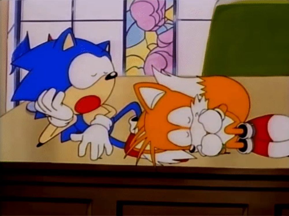 a cartoon of sonic the hedgehog and tails the fox sitting at a table