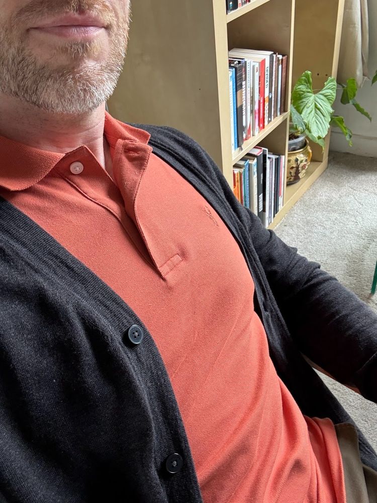Me wearing a lovely burnt orange polo shirt and a dark grey Merino cardigan