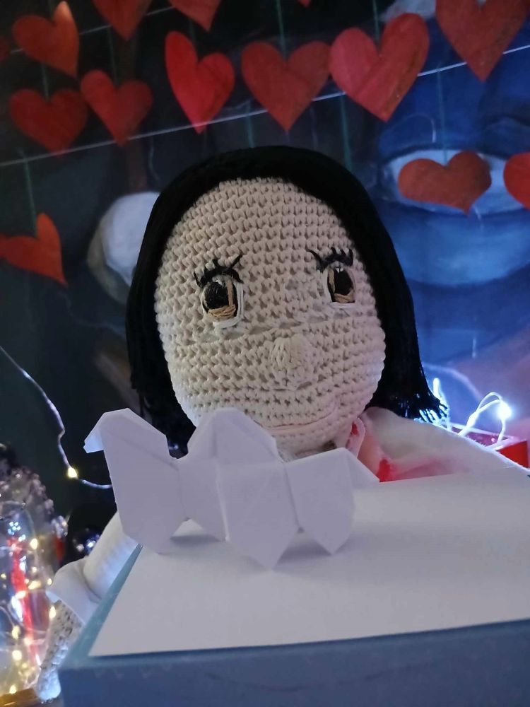 Amigurumi crocheted stuffed boy with two origami horses.