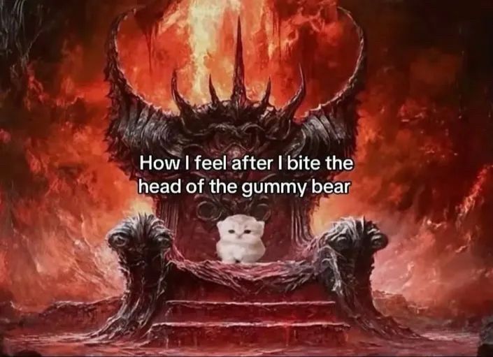 A kitten sitting on a throne of hell Caption: 