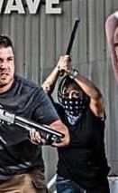 close up of the shotgun wielding dad about to get domed by the crowbar wielding attacker, who appears to be a white woman in jeans wearing a bandana around her face like some white-flight suburban dad’s mental conjuring of what a lefty antifa terrorist looks like.
